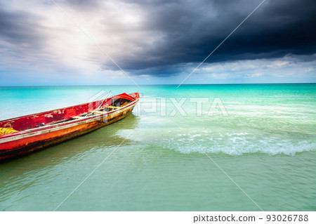Dramatic sky over beach with motorboat, Negril Seven Mile Beach, Jamaica 93026788