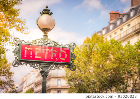 Ornate retro Metro sign entrance in Paris at sunrise, France 93026828