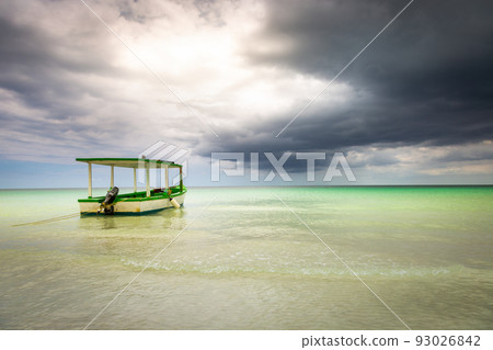Dramatic sky over beach with motorboat, Negril Seven Mile Beach, Jamaica Dramatic sky over beach with motorboat, Negril Seven Mile Beach, Jamaica 93026842