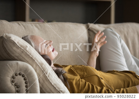 Happy excited mature woman wearing modern headphones 93028022
