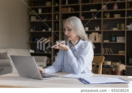 Elderly retired business woman working from home, using laptop Elderly retired business woman working from home, using laptop 93028024