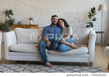 Happy young adult married couple home full length portrait Happy young adult married couple home full length portrait 93028203
