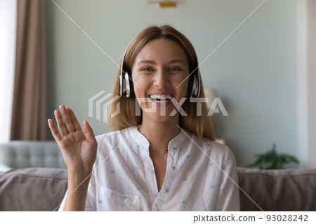 Pretty woman wear headphones greeting friend start video conference Pretty woman wear headphones greeting friend start video conference 93028242