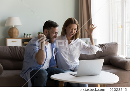 Young couple feel overjoyed get great online news Young couple feel overjoyed get great online news 93028243
