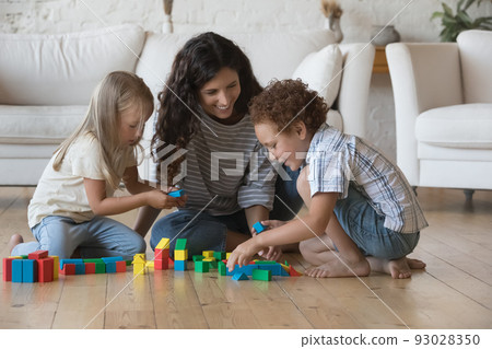 Happy friendly nanny, daycare teacher watching, entertaining children 93028350