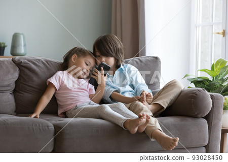 Cute preschoolers kids using smartphone at home Cute preschoolers kids using smartphone at home 93028450