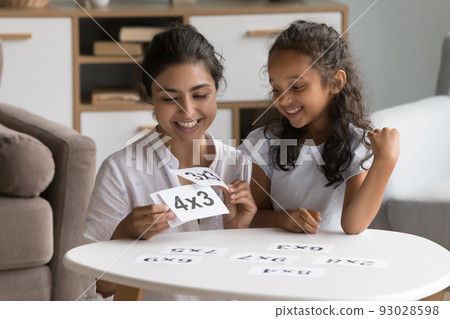 Happy Indian daycare teacher showing flash cards to little kid Happy Indian daycare teacher showing flash cards to little kid 93028598