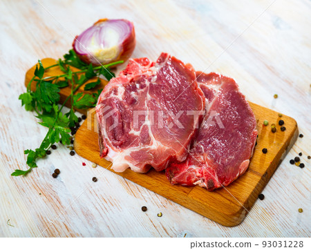 Raw pork chop on cutting board 93031228