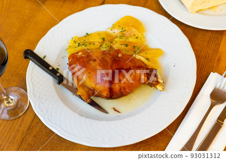 Roasted pork meat, toston asado with slices of potato Roasted pork meat, toston asado with slices of potato 93031312