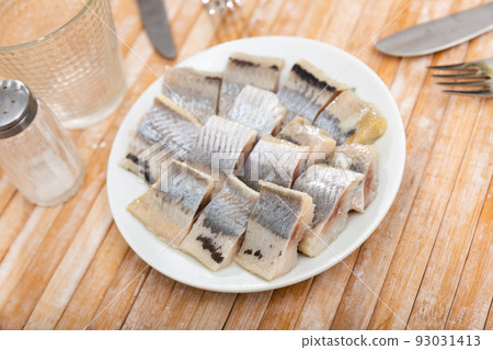 Pieces of herring served on plate Pieces of herring served on plate 93031413