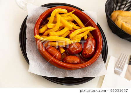 Popular Spanish tapa of smoked chorizo cooked in cider Popular Spanish tapa of smoked chorizo cooked in cider 93031667