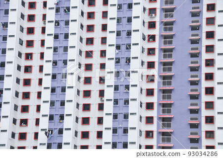 Purple White high-rise residential  flat white apartments with some windows open and clothes hanging out 93034286