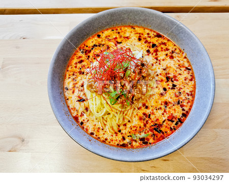 Fire spicy red minced pork tan tan ramen Japanese noodle soup served hot Fire spicy red minced pork tan tan ramen Japanese noodle soup served hot 93034297
