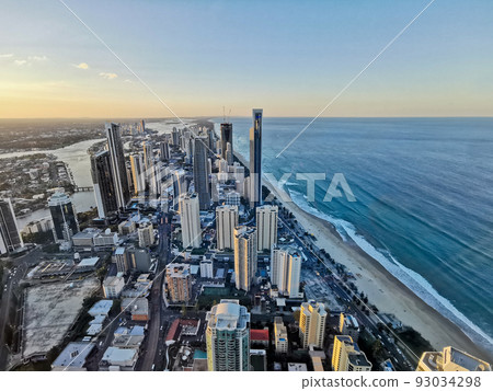 Aerial panorama view of High-rise building sky scrapers in Surfer Paradise beach city skyline landscape with Sunset light in the evening. Aerial panorama view of High-rise building sky scrapers in Surfer Paradise beach city skyline landscape with Sunset light in the evening. 93034298