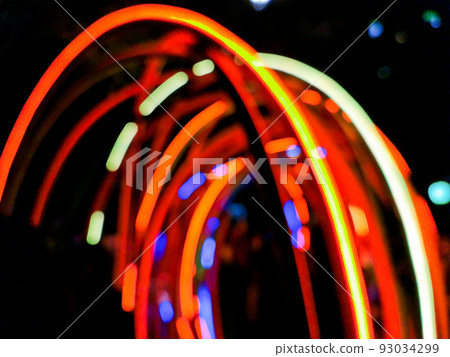 Defocused abtract blurred artistic multicolour light stripes in dark background Defocused abtract blurred artistic multicolour light stripes in dark background 93034299