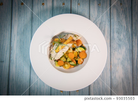 Fish recipe, fillet of sea bass with small vegetables 93035503