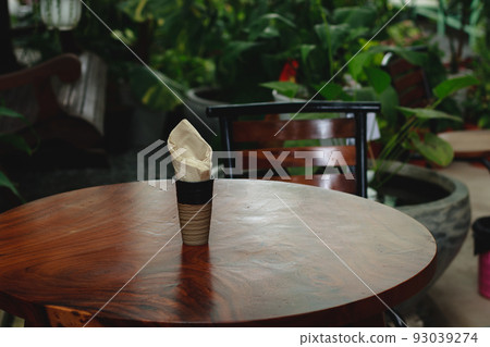 An empty table and chair at a tropical garden An empty table and chair at a tropical garden 93039274
