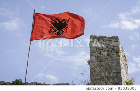 Skodra, Albania, May 12, 2022 - Albanian flag flies over ruins of Rozafa Castle 93039303
