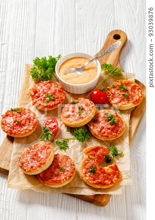 mini pizzas with ham and pecorino cheese, top view mini pizzas with ham and pecorino cheese, top view 93039876