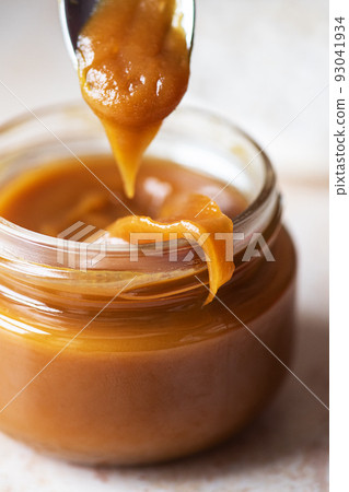 Homemade creamy caramel in a jar. Close up. 93041934