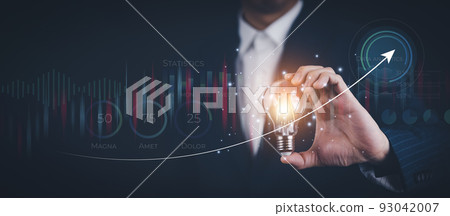 Businessman holding light bulbs, new ideas with of Stock market or forex trading graph and candlestick chart suitable for financial investment, Economy trends background for business idea stock. 93042007