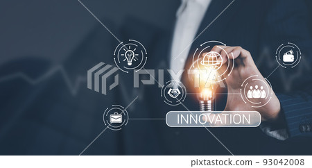 Businessman hand holding light bulb with icons and working on the desk, Creativity and innovation are keys to success.Concept of new idea and innovation with energy and power , working at home, 93042008