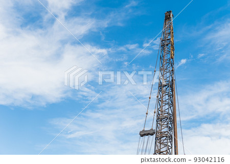 Construction site blue sky and pile driver Construction site blue sky and pile driver 93042116