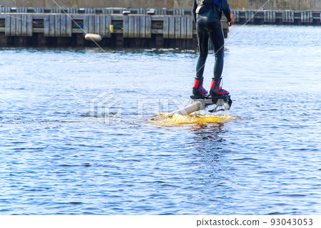 man having fun on Flyboard. Flyboarding in a sunny summer day at river in harbor. Extrime water activity flyboard. man having fun on Flyboard. Flyboarding in a sunny summer day at river in harbor. Extrime water activity flyboard. 93043053