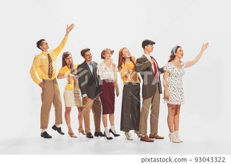 Group of young stylish people standing in a line, talking, expressing ideas isolated over white studio background 93043322