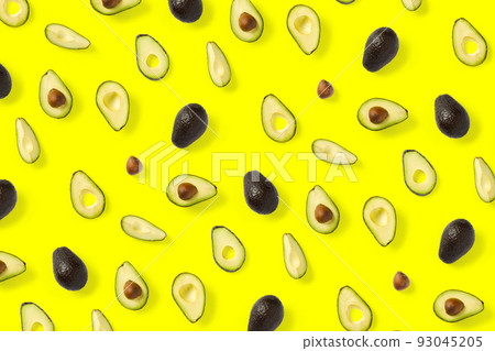 Avocado. Background made from isolated Avocado pieces on yellow background. Flat lay of fresh ripe avocados and avacado pieces. Avocado. Background made from isolated Avocado pieces on yellow background. Flat lay of fresh ripe avocados and avacado pieces. 93045205