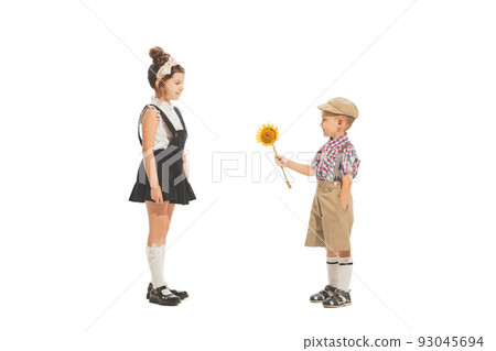 Portrait of little boy and girl, charming kids in retro style outfit, american fashion of 60s, 70s years isolated on white background. Art, childhood, care 93045694