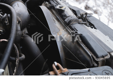 View under the hood of the car. Close-up of a V-shaped six-cylinder old engine. Dirty engine. Time for car maintenance 93045695