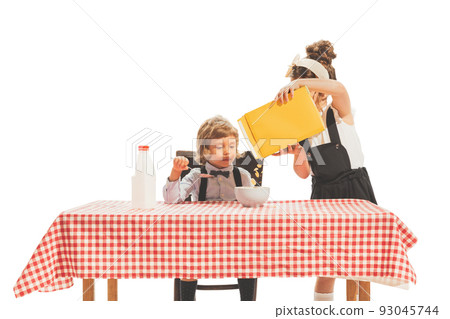 Creative composition with two little kids, boy and girl in retro american style outfits like family couple isolated on white background. Comparison concept Creative composition with two little kids, boy and girl in retro american style outfits like family couple isolated on white background. Comparison concept 93045744