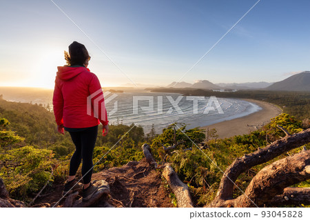 Adventurous Woman Hiker overlooking Sandy Beach on the West Coast of Pacific Ocean Adventurous Woman Hiker overlooking Sandy Beach on the West Coast of Pacific Ocean 93045828