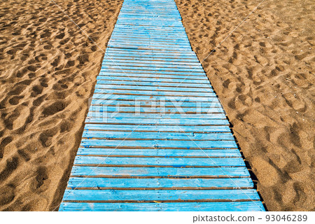 Blue wooden path through sand on the beach Blue wooden path through sand on the beach 93046289