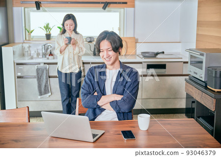 A man thinking with his arms folded during telework 93046379