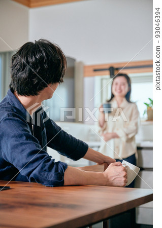 Young couple relaxing in the dining kitchen 93046394