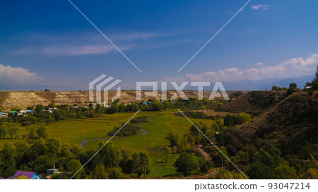 aerial panorama view to Karakol towm, formerly Przhevalsk, and Issyk-Kul lake, Kyrgyzstan 93047214