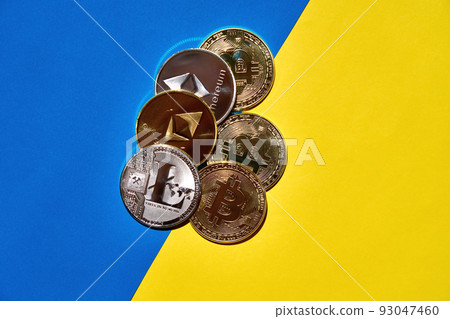 Heap of digital currency golden and silver on yellow and blue background 93047460