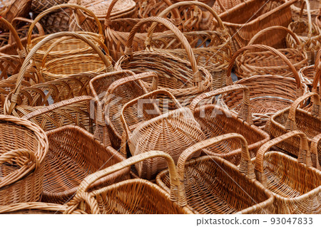 A lot of of many wicker baskets for sale - closeup full-frame background A lot of of many wicker baskets for sale - closeup full-frame background 93047833