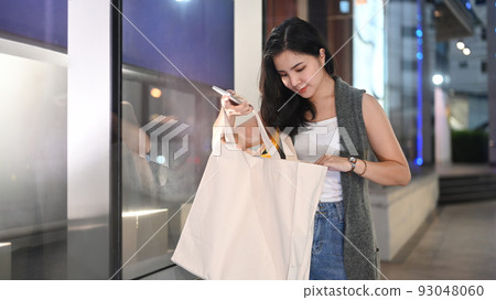 Caucasian shopper woman carrying bags with shopping. 93048060