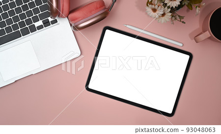 Empty digital tablet and office supply on pink table. 93048063