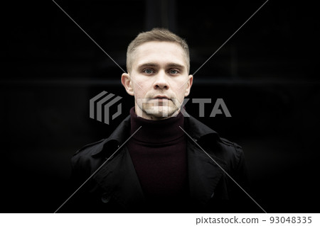 Ukrainian man in black trenchcoat and purple polo Ukrainian man in black trenchcoat and purple polo 93048335