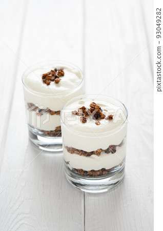 Greek yogurt with granola in glass jar. Parfait Greek yogurt with granola in glass jar. Parfait 93049282