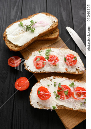 Toasts with microgreens on the table. Healthy food, vegan food and dieting concept. 93049305