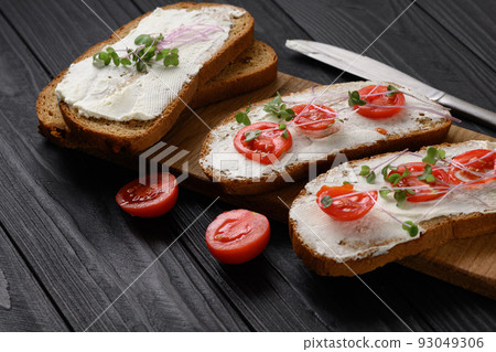 Toasts with microgreens on the table. Healthy food, vegan food and dieting concept. 93049306