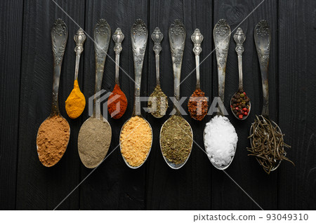 Colorful various herbs and spices for cooking on dark wooden rustic background Colorful various herbs and spices for cooking on dark wooden rustic background 93049310