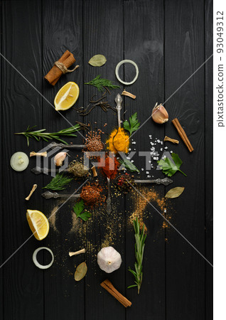 Colorful various herbs and spices for cooking on dark wooden rustic background 93049312