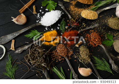 Colorful various herbs and spices for cooking on dark wooden rustic background 93049313