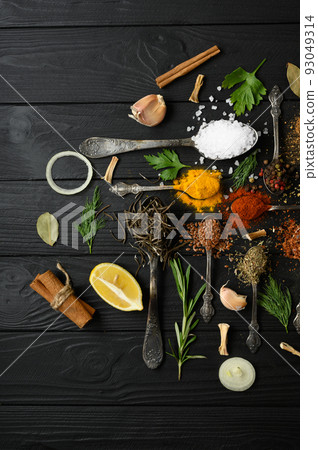 Colorful various herbs and spices for cooking on dark wooden rustic background Colorful various herbs and spices for cooking on dark wooden rustic background 93049314